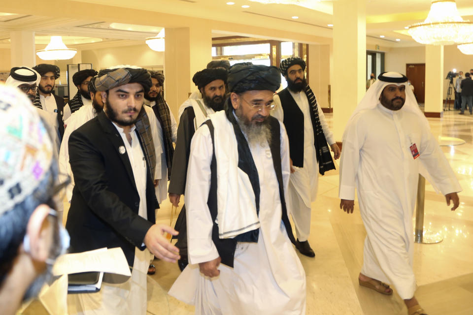Taliban delegation arrive to attend the opening session of the peace talks between the Afghan government and the Taliban in Doha, Qatar, Saturday, Sept. 12, 2020. (AP Photo/ Hussein Sayed)