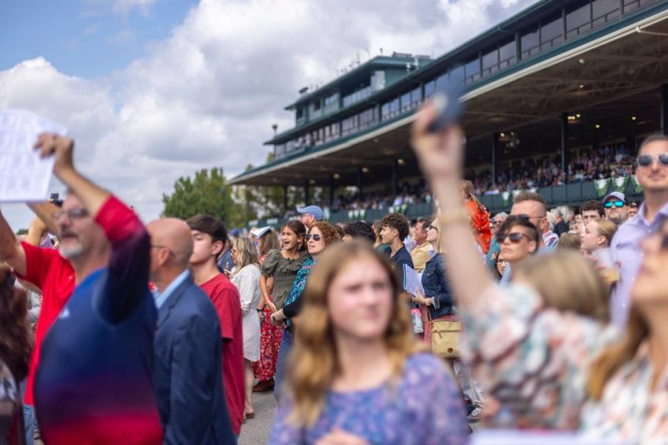 Fans cheer during the first race on a mostly sunny opening day of Keeneland’s Fall Meet on Friday. Ryan C. Hermens/rhermens@herald-leader.com