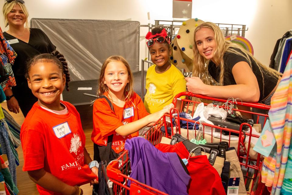 Louisville women's basketball star Hailey Van Lith, far right, poses for a picture with children from the Family Scholar House inside the JCPenney at Mall St. Matthews on Saturday, July 23, 2022, in Louisville, Ky. Van Lith partnered with the department store to provide 20 kids with $150 gift cards for back-to-school shopping sprees.