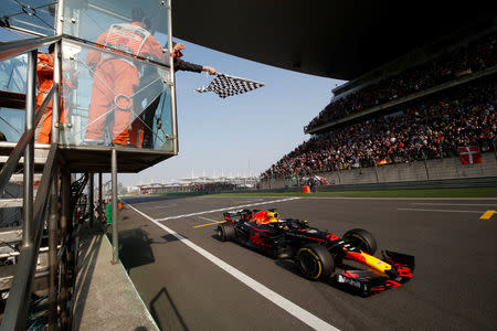 Formula One - F1 - Chinese Grand Prix - Shanghai, China - April 15, 2018 - Red Bull driver Daniel Ricciardo of Australia crosses the checkered flag to win the race. Pool via REUTERS
