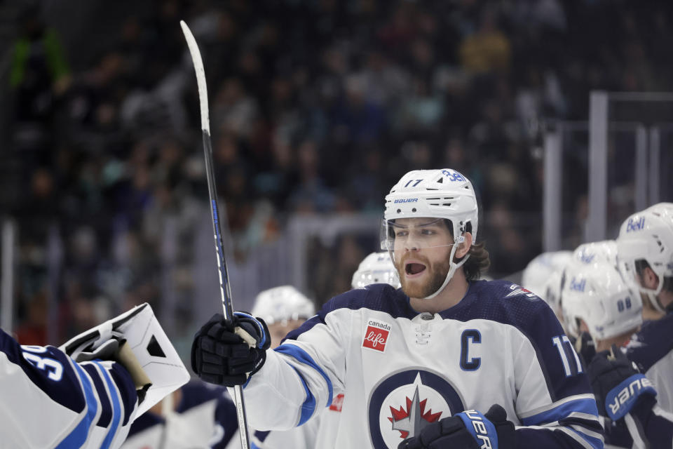 Winnipeg Jets center Adam Lowry (17) celebrates his goal against the Seattle Kraken during the third period of an NHL hockey game, Friday, March 8, 2024, in Seattle. The Jets won 3-0. (AP Photo/John Froschauer)