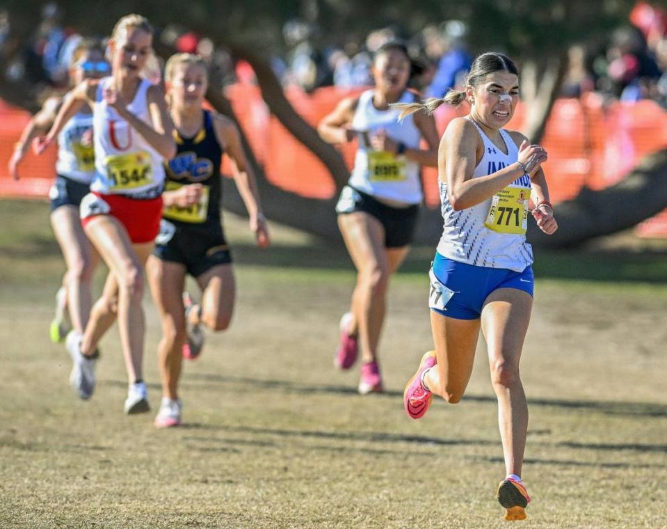 Immanuel’s Sarah Larger, right, guts out the final few meters of the girls Division V state cross country championship race at Woodward Park in Fresno on Saturday, Nov. 25, 2023.