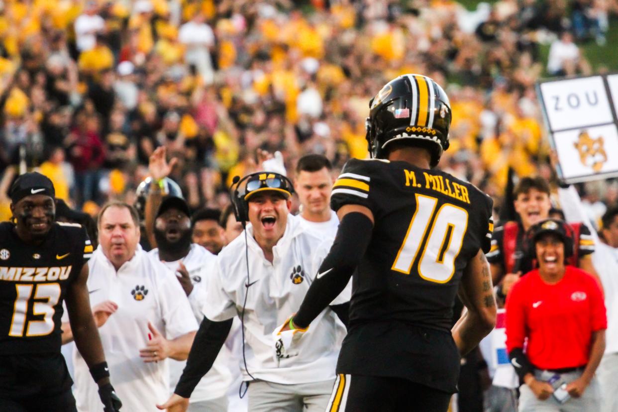 The Missouri football sideline celebrates with Mekhi Miller (10) after Miller scored his first career touchdown against South Dakota at Memorial Stadium on August 31, 2023, in Columbia, Mo.