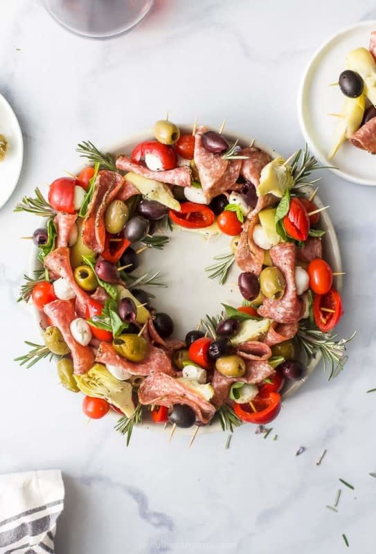 <p>courtesy of Joyful Healthy Eats</p><p>Traditionally, antipasto is a combination of olives, cheese, artichokes, marinaded mushrooms or vegetables and cured meats. Antipasto skewers basically use all of these ingredients and put them on a skewer.</p><p><strong>Get the Recipe: <a href="https://www.joyfulhealthyeats.com/easy-festive-christmas-wreath-antipasto-skewers/?utm_source=feedburner&utm_medium=feed&utm_campaign=Feed%3A+Joyfulhealthyeats+(JoyfulHealthyEats)" rel="nofollow noopener" target="_blank" data-ylk="slk:Christmas Wreath Antipasto Skewers;elm:context_link;itc:0;sec:content-canvas" class="link ">Christmas Wreath Antipasto Skewers</a></strong></p>