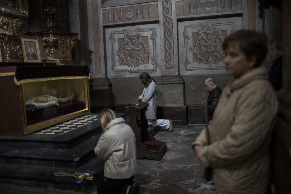 People pray during a mass on Orthodox Palm Sunday.