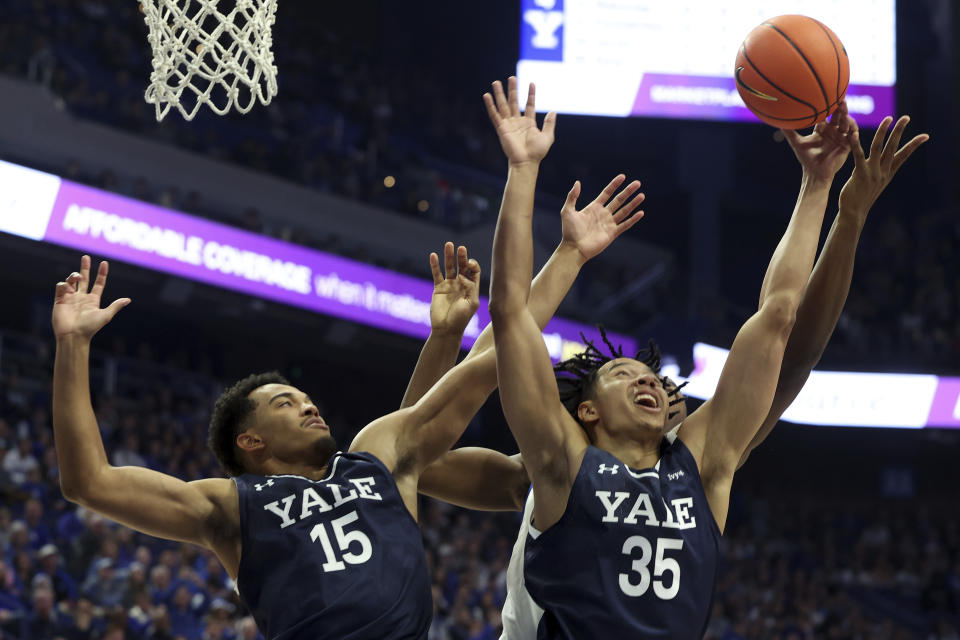 Yale's EJ Jarvis (15) and Isaiah Kelly (35) go for a rebound in front of Kentucky's Oscar Tshiebwe (34) during the first half of an NCAA college basketball game in Lexington, Ky., Saturday, Dec. 10, 2022. (AP Photo/James Crisp)