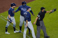 FILE - In this Sept. 1, 2020, file photo, Tampa Bay Rays pinch-hitter Michael Brosseau, left, is restrained by a coach as second base umpire Chad Fairchild (4) warns New York Yankees relief pitcher Aroldis Chapman to stay away from Brosseau as the two players exchanged words following the Rays' 5-3 loss to the Yankees in a baseball game at Yankee Stadium in New York. The altercation started after Chapman threw a high pitch at Brosseau. The Rays wear blue T-shirts with four horses lined up behind a fence, a reference to Tampa Bay manager Kevin Cash declaring "I’ve got a whole damn stable full of guys that throw 98 miles an hour" in response to Aroldis Chapman throwing near the Mike Brosseau's head on Sept. 1. (AP Photo/Kathy Willens, File)