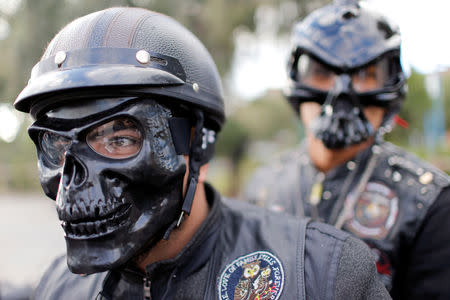 A member of the Iraq Bikers, the first Iraqi biker group, wears a mask as he drives his motorbike on the streets of Baghdad, Iraq December 28, 2018. REUTERS/Thaier Al-Sudani