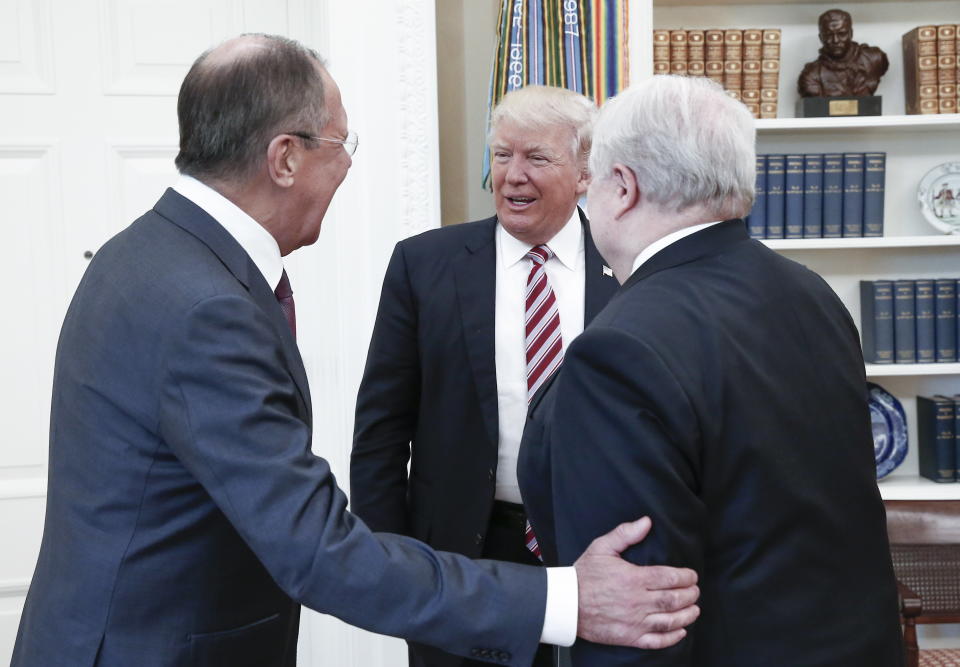 Russia's Foreign Minister Sergei Lavrov, President Donald Trump, and Russian Ambassador to the United States Sergei Kislyak talking during a meeting in the Oval Office.