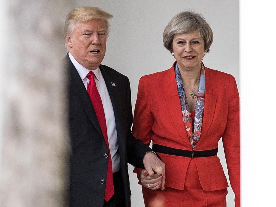 Theresa May holding hands with Donald Trump (Getty)