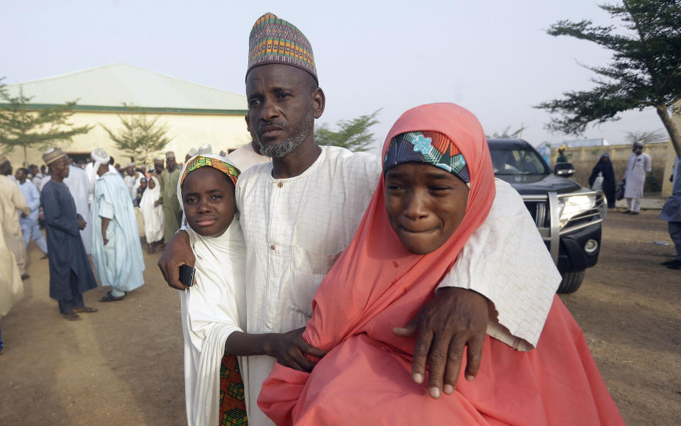 Parents are reunited with their daughters in Jangabe, Nigeria, Wednesday, March 3, 2021. More than 300 schoolgirls kidnapped last week in an attack on their school in northwest Nigeria have arrived in Jangabe after been freed on Tuesday. The Girls were abducted few days ago from Government Girls Secondary School in Jangabe in Zamfara state (AP Photo/Sunday Alamba)