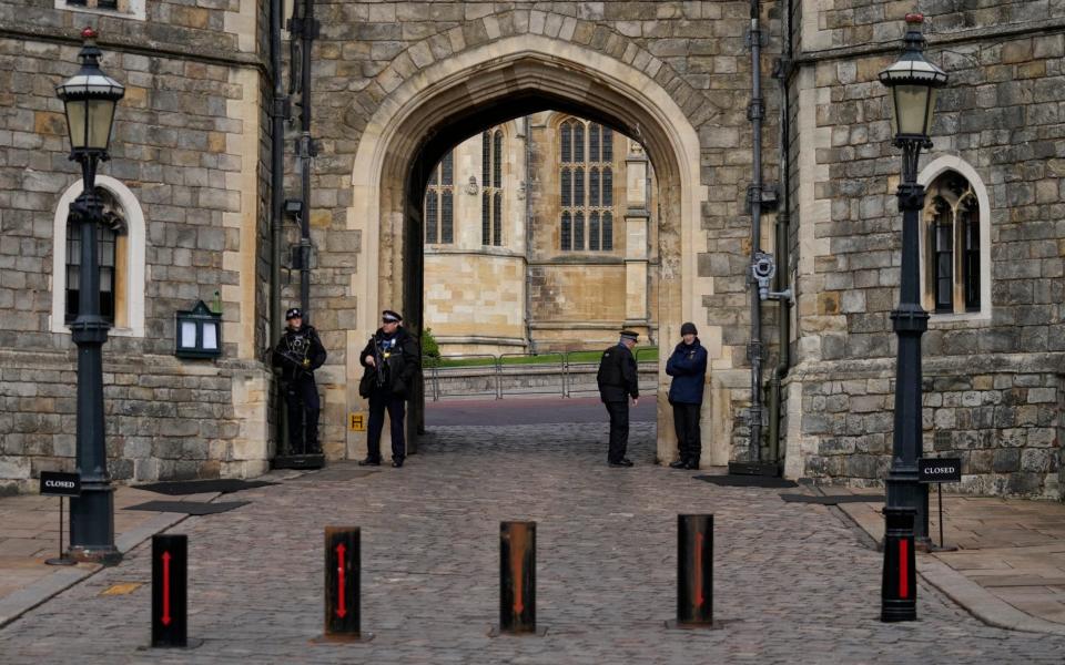 Police guard the Henry VIII gate to Windsor Castle - AP