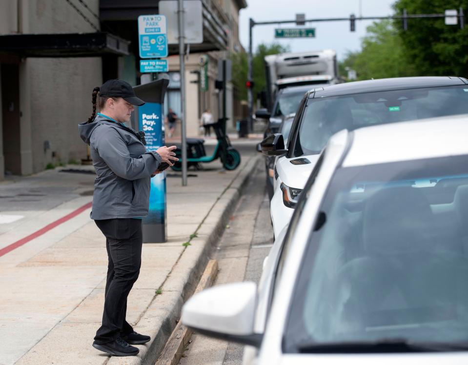 Parking Ambassador Celeste Taylor monitors street parking in downtown Pensacola on Wednesday, March 29, 2023. City officials are conducting a strategic review of how the city handles parking.