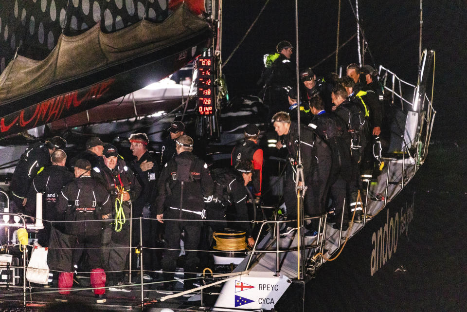 Crew from Andoo Comanche react after crossing the finish line to win the Sydney Hobart yacht race in Hobart, Australia, in the early hours of Wednesday, Dec. 28, 2022. (Linda Higginson/AAP Image/Linda Higginson via AP)