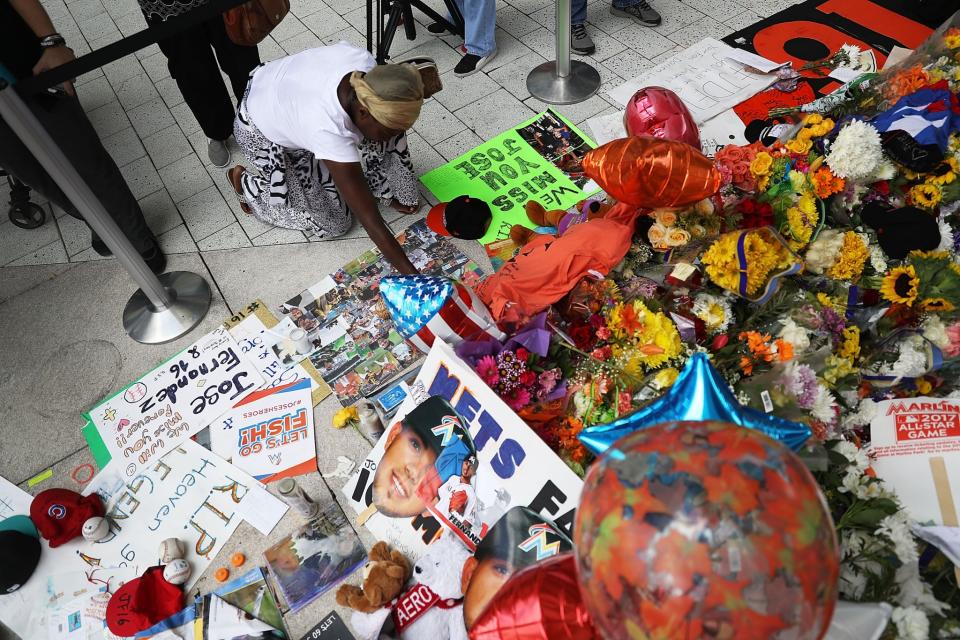 <p>Patricia Collins pays her respects at a memorial before the hearse carrying Miami Marlins pitcher Jose Fernandez passes in front of the Marlins baseball stadium on September 28, 2016 in Miami, Florida. Mr. Fernandez was killed in a weekend boat crash in Miami Beach along with two friends. (Photo by Joe Raedle/Getty Images) </p>