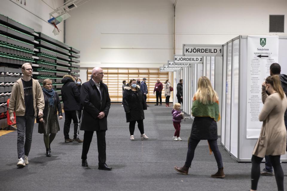 People vote at a local sports complex in Kopavogur, Iceland, Saturday, Sept. 25, 2021. Icelanders are voting in a general election dominated by climate change, with an unprecedented number of political parties likely to win parliamentary seats. (AP Photo/Arni Torfason)