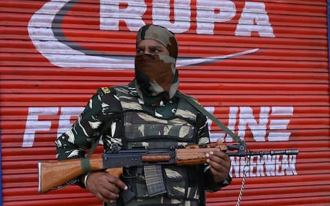 An Indian paramilitary trooper stands guard in Srinagar - Credit: TAUSEEF MUSTAFA/AFP/Getty Images