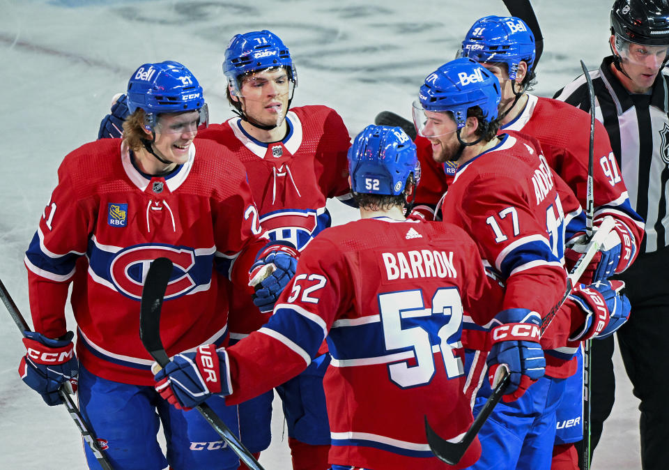 Montreal Canadiens' Josh Anderson (17) celebrates with teammates after scoring against the New York Islanders during the second period of an NHL hockey match in Montreal, Saturday, Dec. 16, 2023. (Graham Hughes/The Canadian Press via AP)