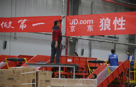 An employee works at a JD.com logistics centre in Langfang, Hebei province, November 10, 2015. REUTERS/Jason Lee/File Photo