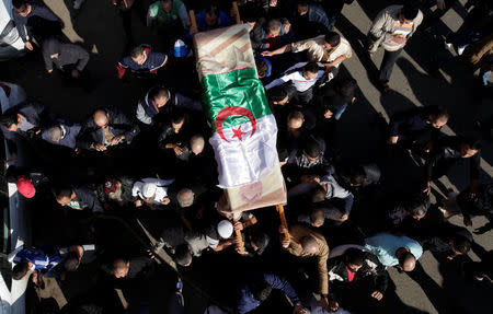 Relatives carry the coffin of British-Algerian journalist Mohamed Tamalt, British-Algerian journalist who had died six months after staging a hunger strike in Algiers over his detention for publishing articles seen as offensive to President Abdelaziz Bouteflika, during his funeral in Algiers, Algeria December 12, 2016. REUTERS/ Ramzi Boudina