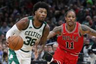 Boston Celtics' Marcus Smart (36) drives past Chicago Bulls' DeMar DeRozan (11) during the second half of an NBA basketball game, Monday, Nov. 1, 2021, in Boston. (AP Photo/Michael Dwyer)