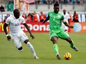 Nigeria defender Joseph Yobo (2) passes the ball as United States forward Jozy Altidore (17) defends during the first half at EverBank Field. Mandatory Credit: Kim Klement-USA TODAY Sports