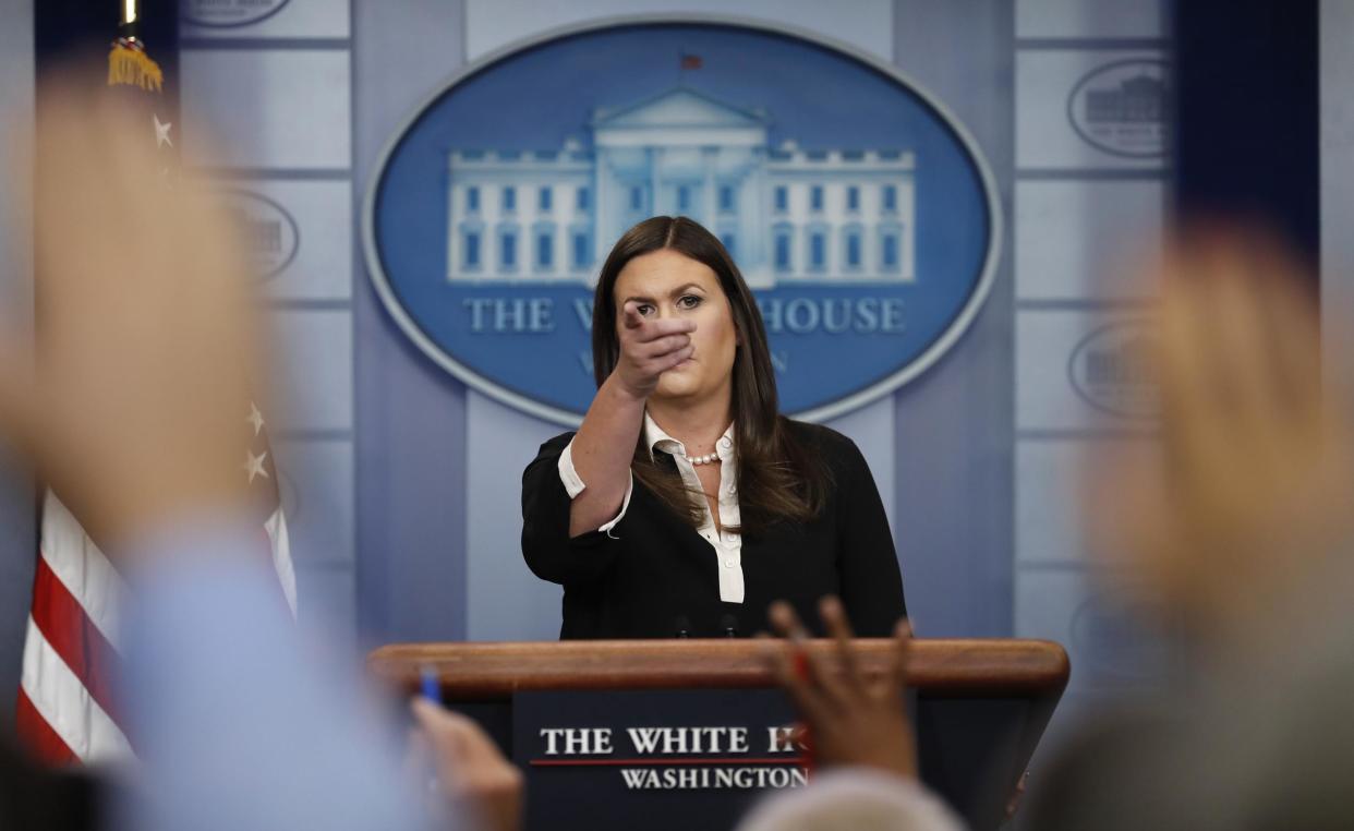 White House press secretary Sarah Huckabee Sanders points to a reporter during the daily news briefing at the White House: (AP Photo/Carolyn Kaster