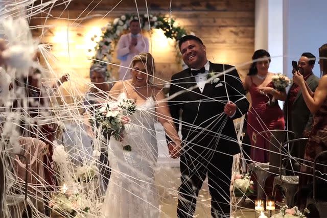 <p>TATIANA DELGADO/Instagram</p> Bride Lupe Jacquez's wedding dress and veil caught on fire right after her wedding to Luis Quijano.