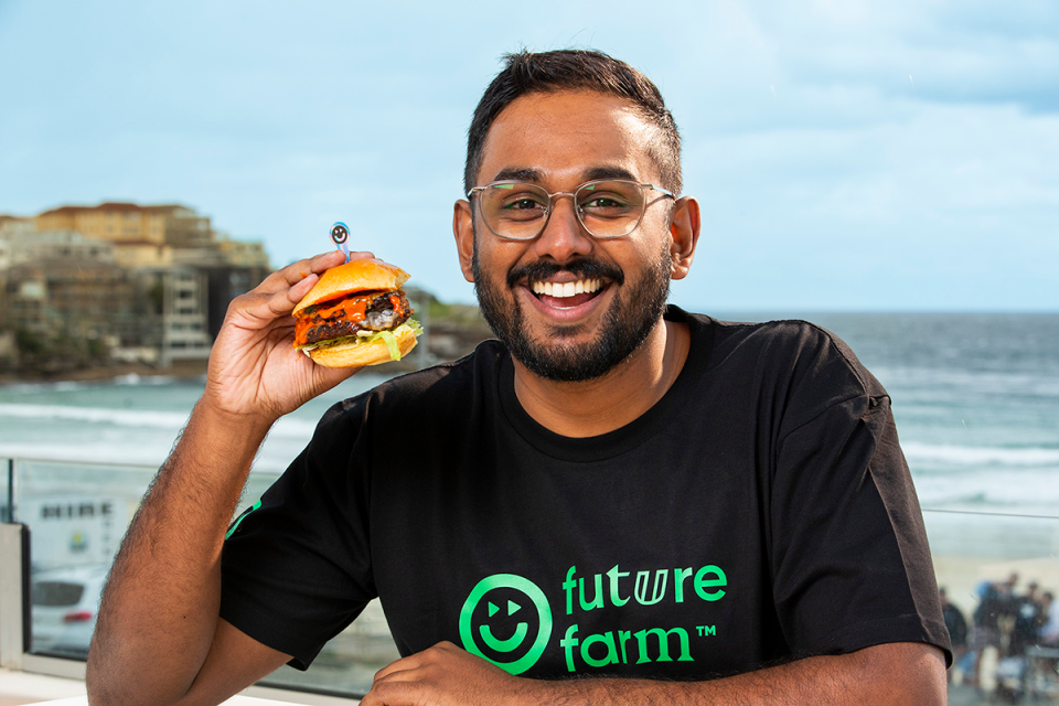 MasterChef's Justin Narayan eating a Future Farm Smash Burger.