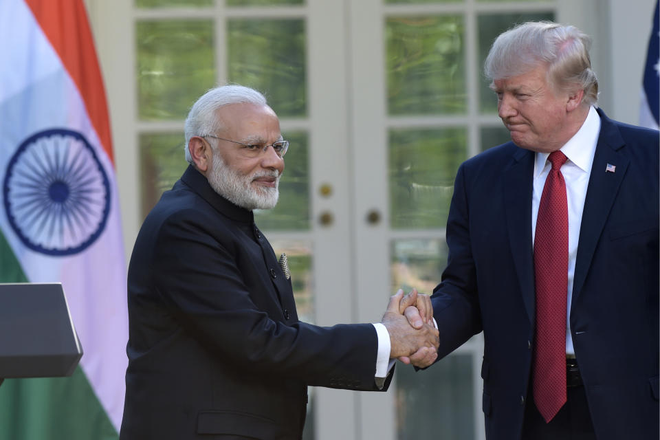 FILE - In this June 26, 2017, file photo, U.S. President Donald Trump and Indian Prime Minister Narendra Modi shake hands after making statements in the Rose Garden of the White House in Washington. Modi won a second term in office in May, 2019, by presenting a muscular image to voters by ordering an air strike inside Pakistan in response to a suicide attack on Indian paramilitary forces in troubled Kashmir ahead of national elections. But he will now be required to navigate deftly in a climate of deteriorating trade relations between the United States and China and its fallout on India and rising tensions between the United States and Iran. (AP Photo/Susan Walsh, File)