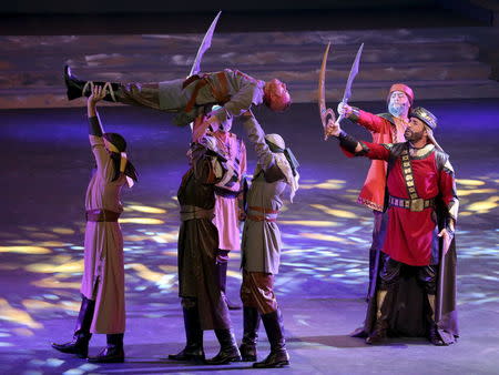 Cast members act in "Al Faris" or "The Knight", a musical set to poetry penned by Dubai's monarch Sheikh Mohammed bin Rashid al-Maktoum, during its premiere in Dubai January 6, 2016. REUTERS/Ashraf Mohammad