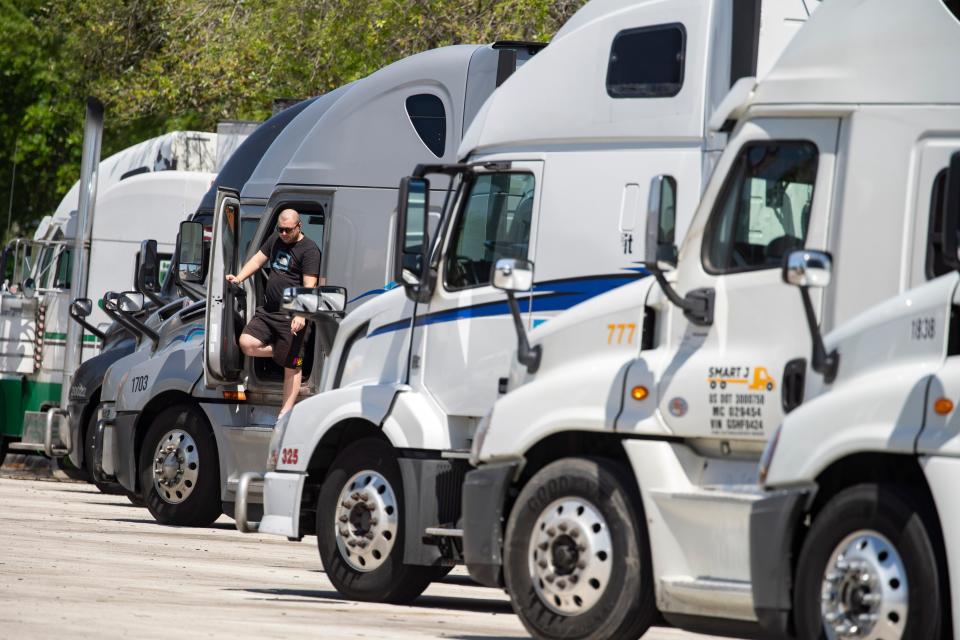 A driver takes a break before heading north from the Florida Turnpike service plaza on March 11, 2024 in West Palm Beach, Florida.