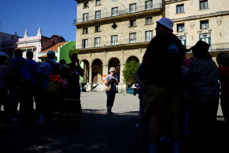 Tourists take a tour through the historic centre in Havana, Cuba, April 10, 2018. REUTERS/Alexandre Meneghini