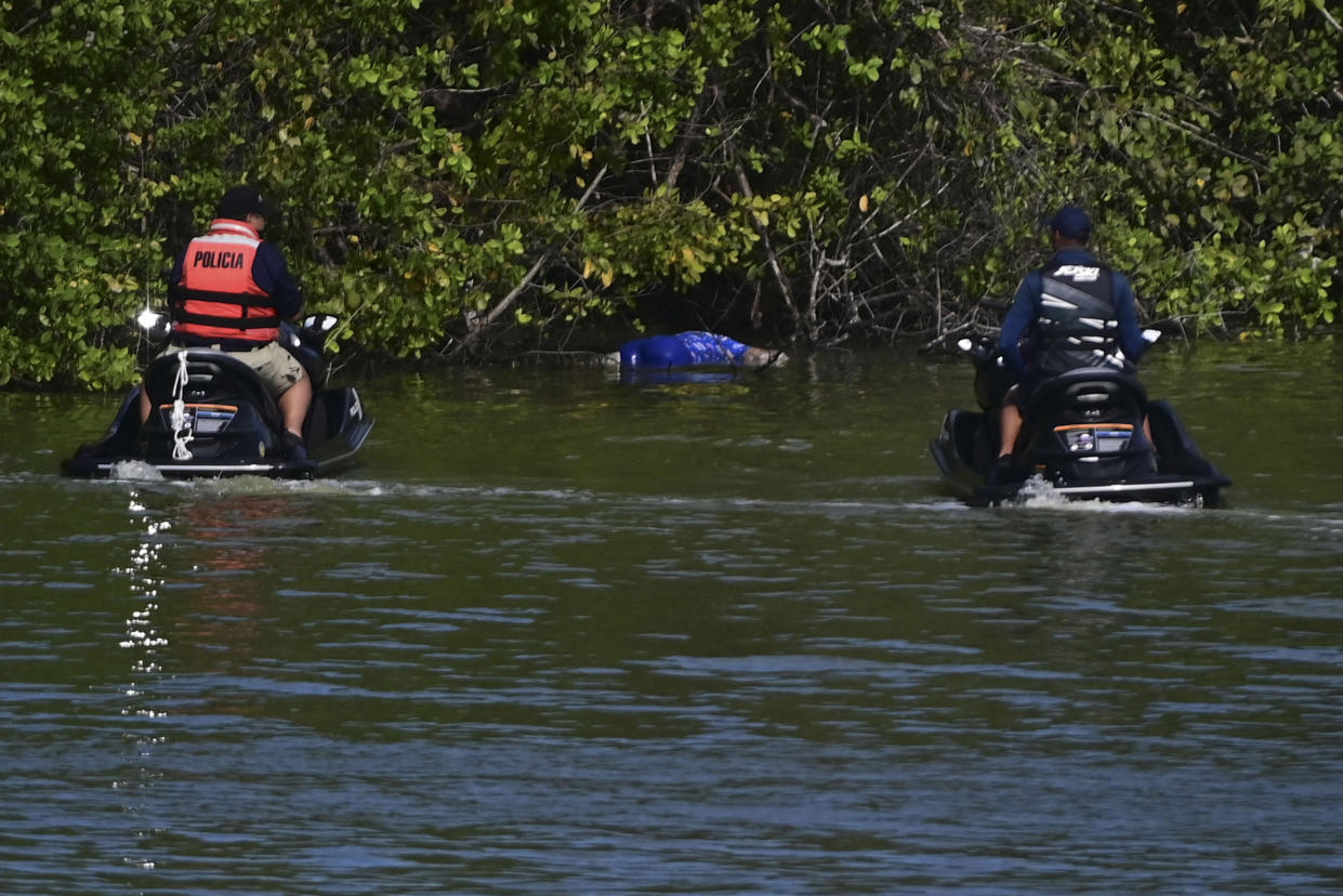 Authorities look at the body of 27-year-old Keishla Rodriguez in the San Jose lagoon after she was reported missing in San Juan, Puerto Rico, Saturday, May 1, 2021.  A federal judge on Monday ordered Puerto Rican boxer Félix Verdejo held without bail after he was charged in the death of Rodriguez, his pregnant lover. (AP Photo/Carlos Giusti)