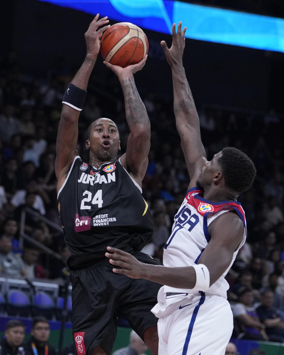 Jordan forward Rondae Hollis Jefferson (24) shoots over U.S. guard Anthony Edwards (10) during the first half of a Basketball World Cup group C match in Manila, Philippines Wednesday, Aug. 30, 2023. (AP Photo/Michael Conroy)