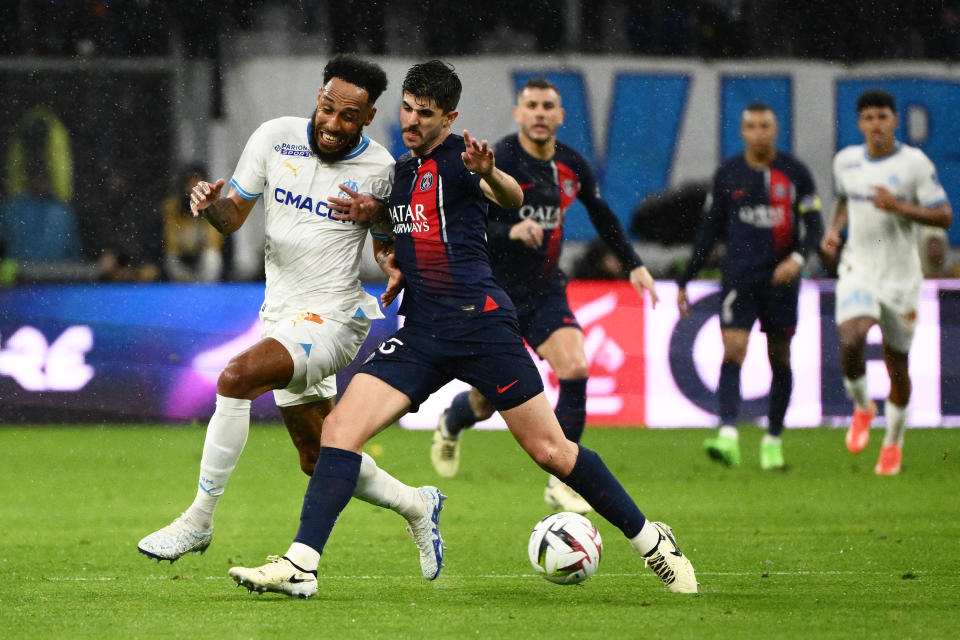 Paris Saint-Germain's Brazilian defender #35 Lucas Beraldo (C) elbows Marseille's French-Gabonese forward #10 Pierre-Emerick Aubameyang (L) as they fight for the ball leading to Beraldo receiving a red card  during the French L1 football match between Olympique Marseille (OM) and Paris Saint-Germain (PSG) at Stade Velodrome in Marseille, southeastern France, on March 31, 2024. (Photo by CHRISTOPHE SIMON / AFP) (Photo by CHRISTOPHE SIMON/AFP via Getty Images)