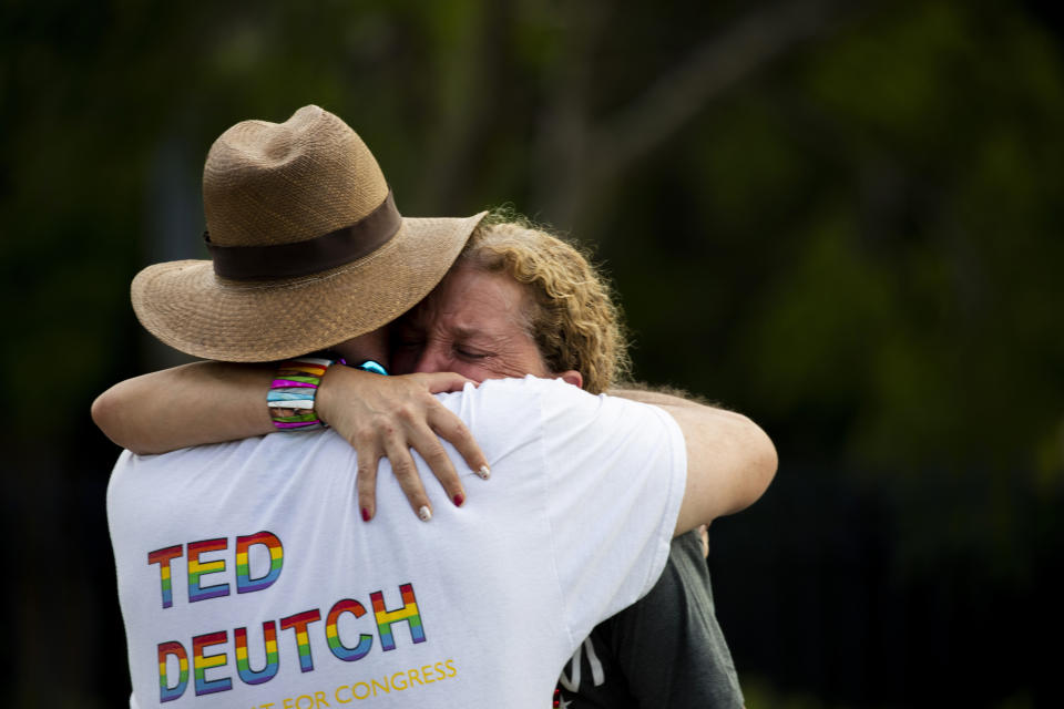 Rep. Debbie Wasserman Schultz, D-Fla., is comforted after a truck drove into a crowd of people during The Stonewall Pride Parade and Street Festival in Wilton Manors, Fla., Saturday, June 19, 2021. A driver has slammed into spectators at the start of a Pride parade in South Florida, injuring at least two people. Wilton Manors police tweeted Saturday night that the parade was canceled due to a “tragic event.” (Chris Day/South Florida Sun-Sentinel via AP)