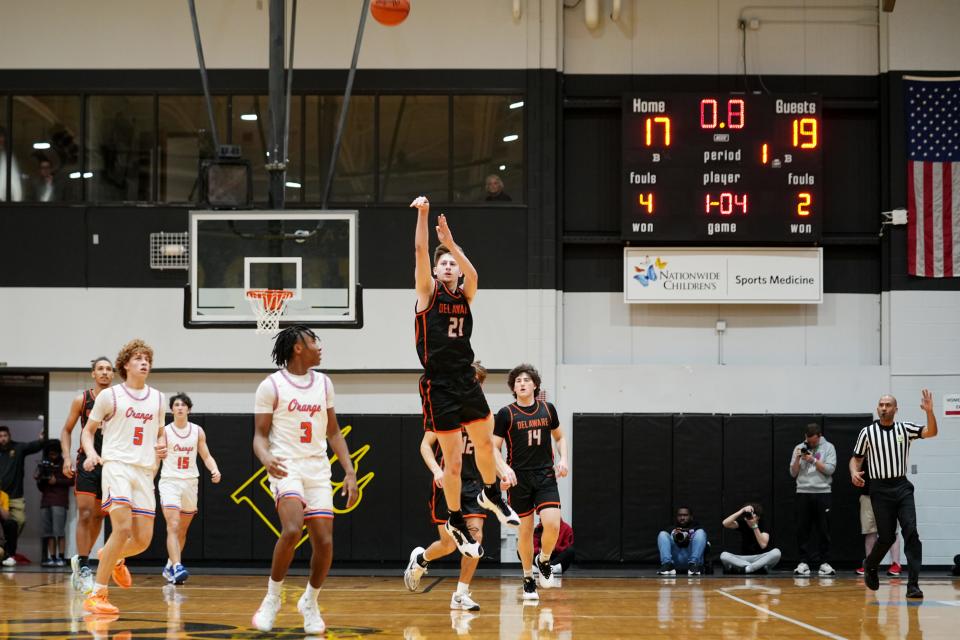 Delaware Hayes' Jesse Burris makes a 3-pointer at the first-quarter buzzer in Saturday's regional final.