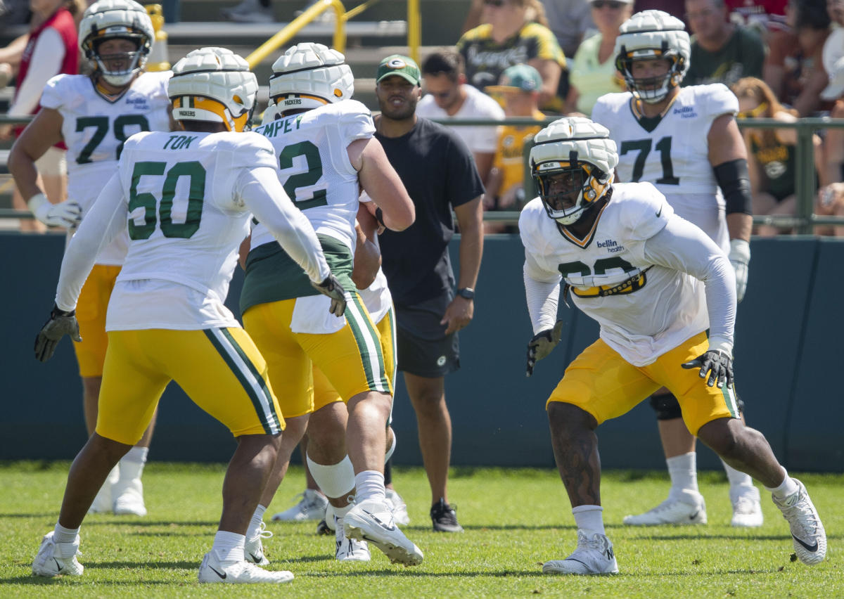 Green Bay Packers guard Zach Tom (50) runs on the field during the first  half of