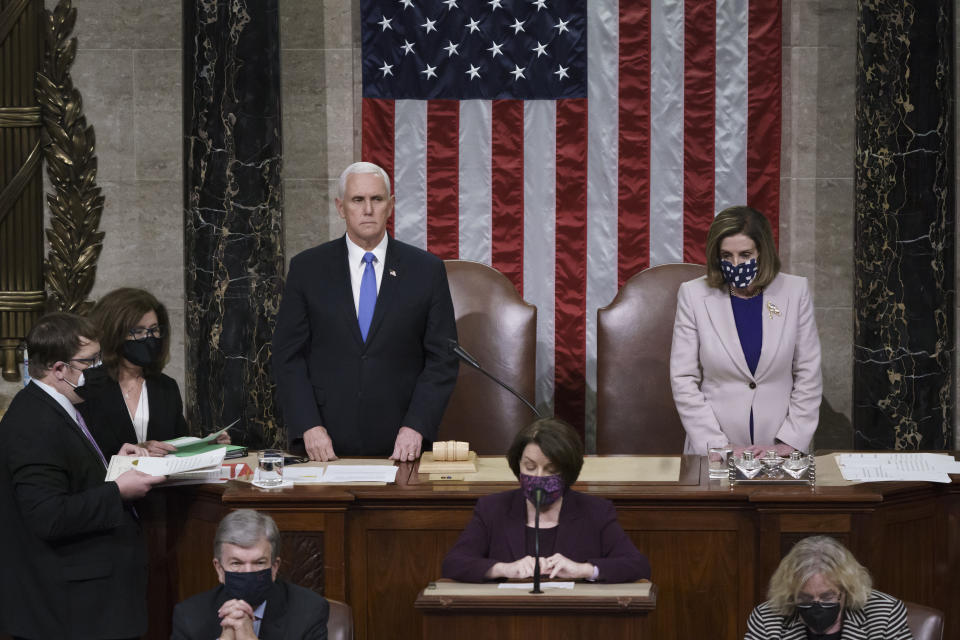 Vice President Mike Pence and House Speaker Nancy Pelosi read the final certification of Electoral College votes cast in the 2020 presidential election during a joint session of Congress, Jan. 7, 2021. (J. Scott Applewhite/Getty Images)