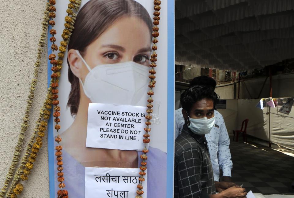 A volunteer waits outside a vaccination center which has been closed because of shortage of the COVID-19 vaccine in Mumbai, India, Friday, April 9, 2021. India has a seven-day rolling average of more than 100,000 cases per day and has reported 13 million virus cases since the pandemic began, the third-highest total after the United States and Brazil. (AP Photo/Rajanish Kakade)