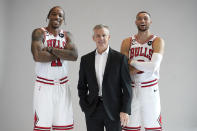 Chicago Bulls head coach Billy Donovan, center, DeMar DeRozan (11) and Zach LaVine pose for photographers during the NBA basketball team's Media Day, Monday, Sept. 26, 2022, in Chicago. (AP Photo/Charles Rex Arbogast)