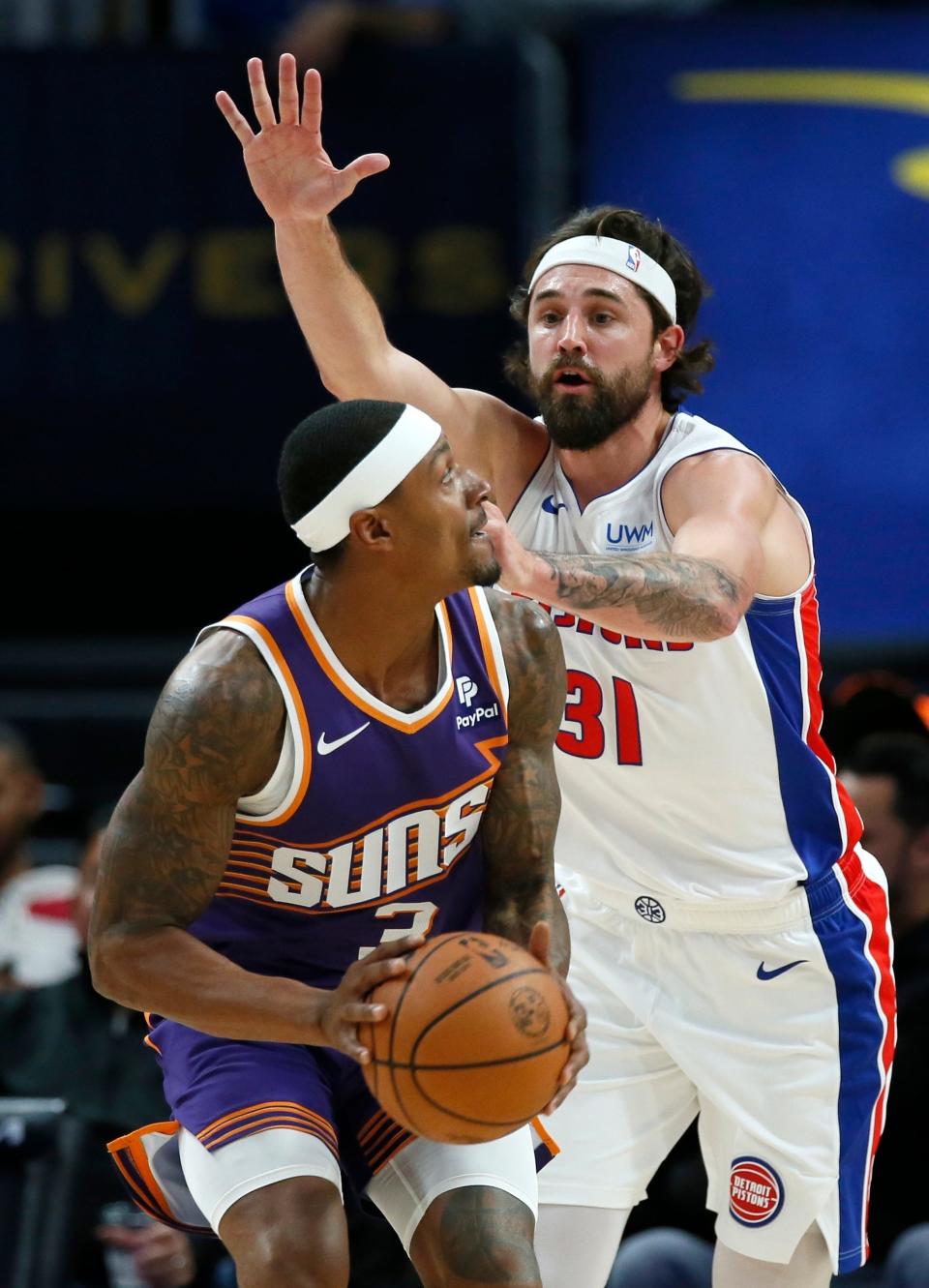 Pistons forward Joe Harris guards against Suns guard Bradley Beal during the first half of a preseason game on Sunday, Oct. 8, 2023, at Little Caesars Arena.