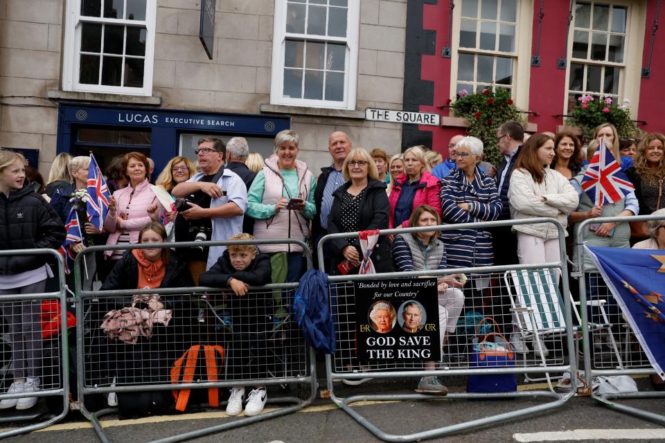 People wait in Royal Hillsborough for the visit of Britain's King Charles, following the death of Britain's Queen Elizabeth, at Royal Hillsborough, Northern Ireland (REUTERS)