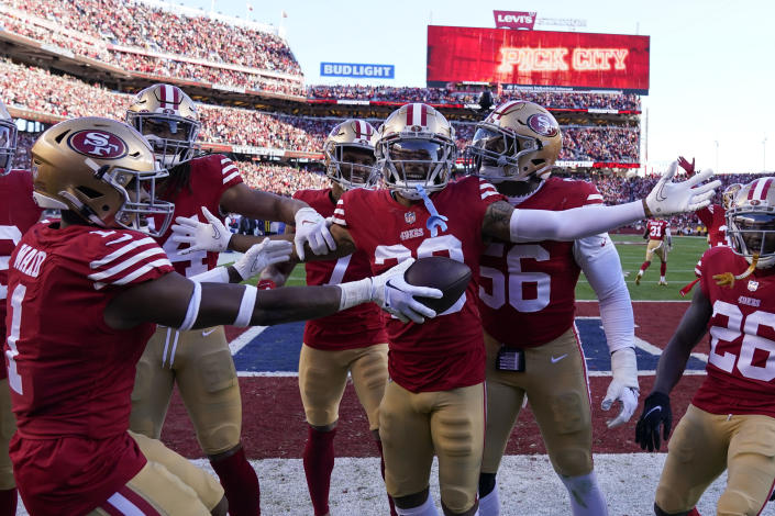 San Francisco 49ers cornerback Deommodore Lenoir, middle, celebrates with teammates after intercepting a pass against the Dallas Cowboys during the first half of an NFL divisional round playoff football game in Santa Clara, Calif., Sunday, Jan. 22, 2023. (AP Photo/Godofredo A. Vásquez)