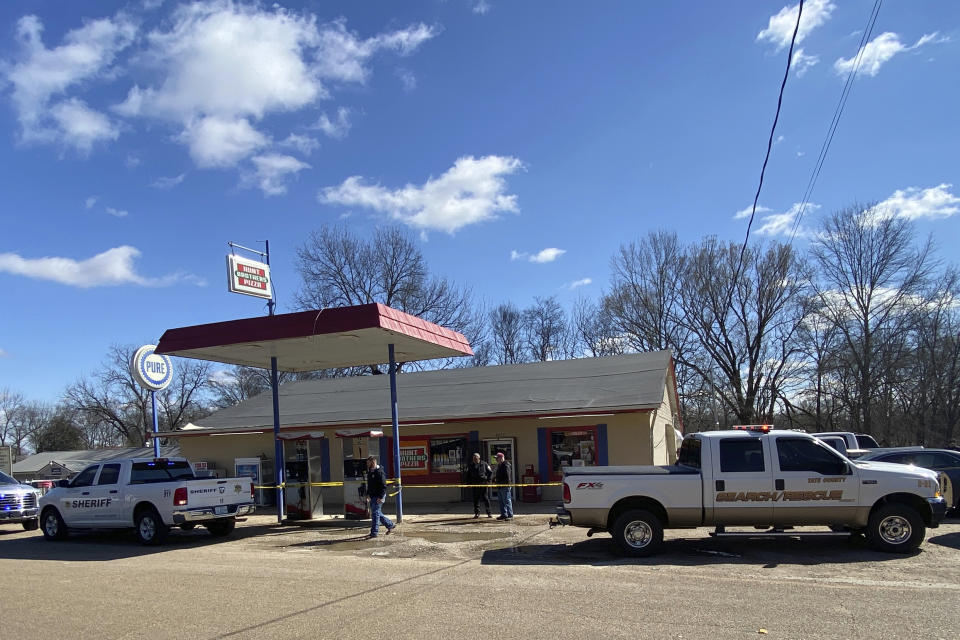 Law enforcement personnel work at the scene of a shooting, Friday, Feb. 17, 2023, in Arkabutla, Miss. Six people were fatally shot Friday in the small town in rural Mississippi near the Tennessee state line, and authorities said they had taken a suspect into custody. (Adam Itayem/NewsNation via AP)