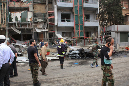 Syrian army soldiers gather in front of the al-Dabit maternity clinic after it was hit by rockets fired by insurgents in government-held parts of Aleppo city, Syria, in this handout picture provided by SANA on May 3, 2016. SANA/Handout via REUTERS
