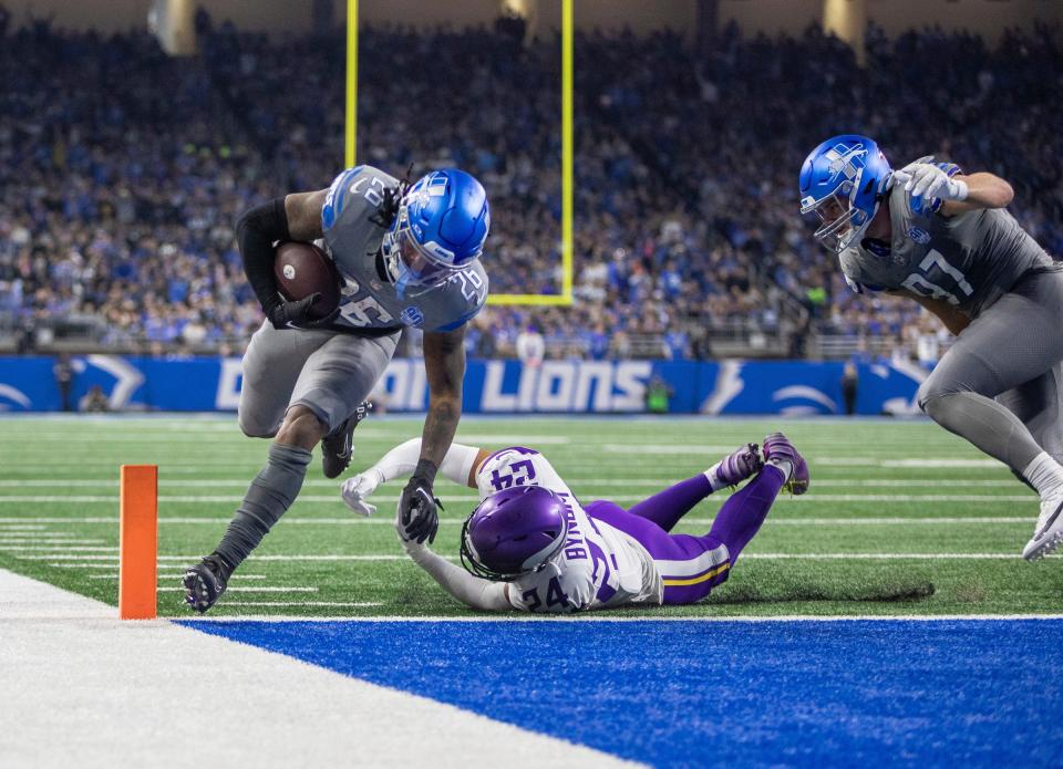 Detroit Lions running back Jahmyr Gibbs runs for a 3-yard touchdown against Minnesota Vikings defender Camryn Bynum during the first quarter at Ford Field in Detroit on Sunday, Jan. 7, 2024.