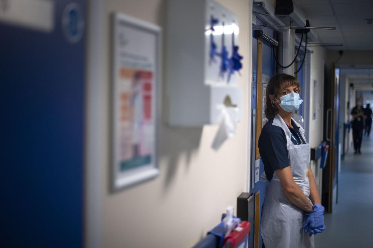 A support worker stands in a corridor as the first patients are admitted to the NHS Seacole Centre at Headley Court, Surrey