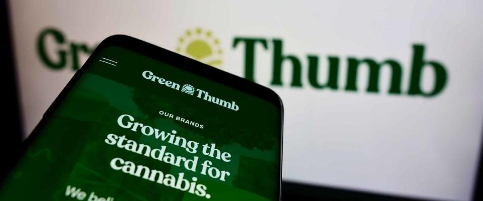 STUTTGART, GERMANY - Aug 14, 2021: Mobile phone with webpage of American cannabis company Green Thumb Industries Inc  on screen in front of logo  Focus on top-left of phone display